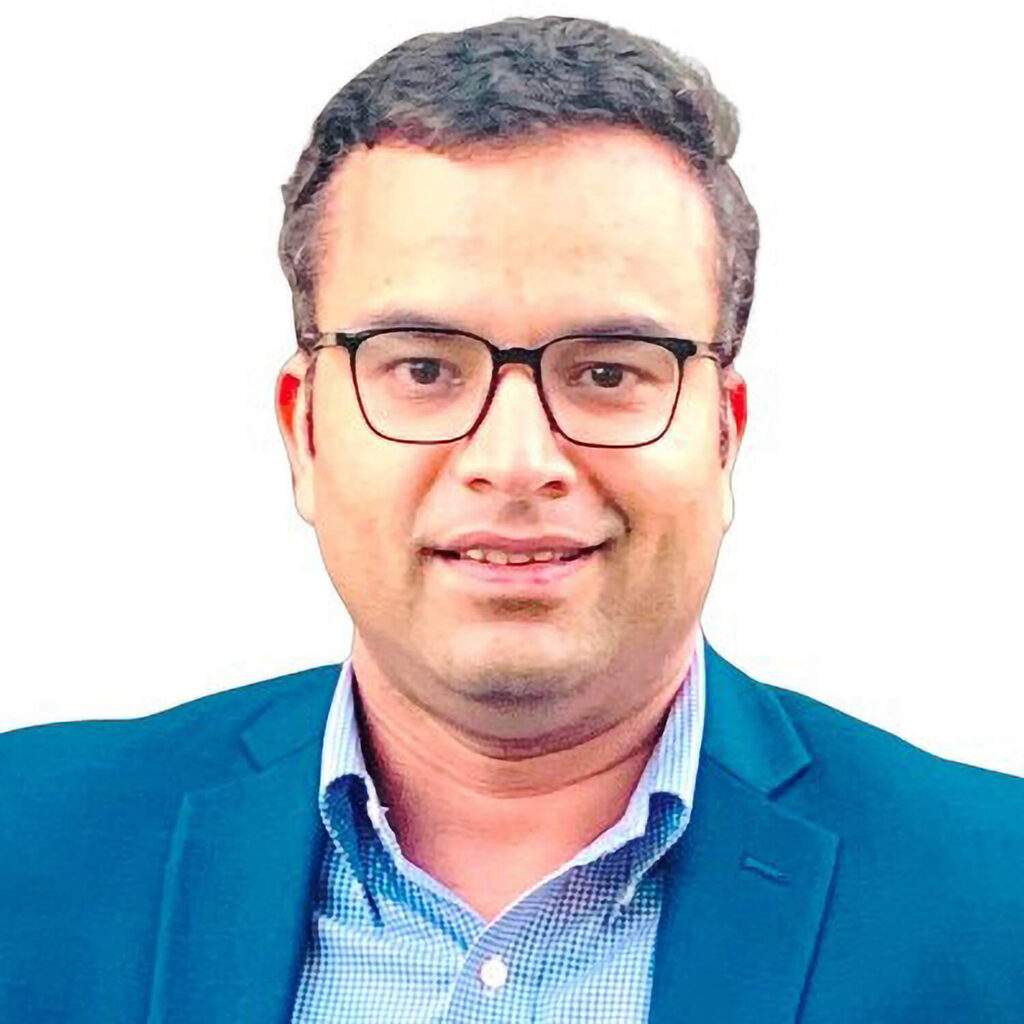 File photo - headshot of Delphon COO Pradeep Mishra in a blue gingham dress shirt and navy blazer.